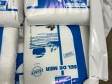 several packages of toilet paper are wrapped in plastic bags