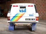 a van that is parked in a garage with a rainbow painted on the back