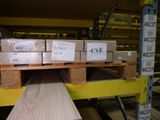 many boxes of wood on a pallet in a warehouse