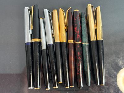 several pens are lined up in a row on a table