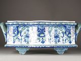 blue and white planter with floral designs on the sides