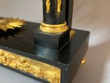 a black and gold clock sitting on a table