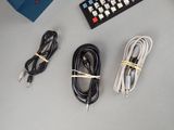 a remote, a controller, and other electronics laid out on a table