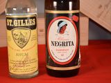 two bottles of liquor sitting next to each other on a table