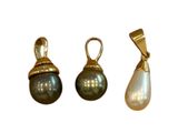three different types of pearl pendants on a white background