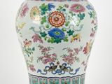 a large vase with a lid on a wooden stand