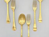 gold plated flatware set with spoons, forks and spoons