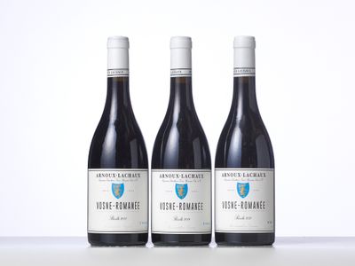 three bottles of wine sitting on top of a table next to each other