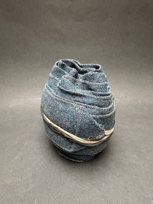 grey felt bag with a string tied around it