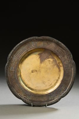 a gold plate with a picture of a man on it