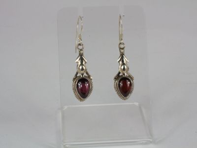 silver earrings with garnets and garnets on them