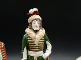 a figurine of a man standing next to a horse