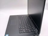 a laptop with a black keyboard on a white table