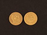 two gold coins, one of which has a head and the other of which has a crown on it
