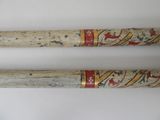 two baseball bats with designs on them on a table