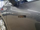 a close up of a car door with a sticker on it