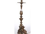a brass plated table lamp with a glass shade on top