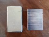 two lighters sitting on top of a wooden table next to each other