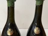 three bottles of wine sitting next to each other on a table