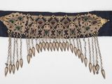 un gros plan d'une ceinture ornée d'une chaîne et de perles