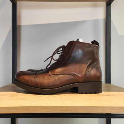 des bottes en cuir marron posées sur une étagère dans un magasin de chaussures