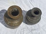 two brown vases sitting on a white surface