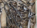 a lot of spoons and spoon knives in a box