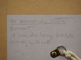 a note written on a piece of paper next to a key