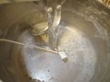 a metal bowl with a toothbrush inside of it