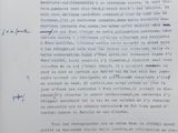 an old document with blue writing on it sitting on top of a table