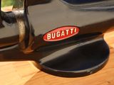 a close up of a black and red machine on a wooden table