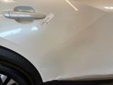 a close up of a white car with a sticker on it