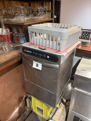 a silver dishwasher sitting on top of a cart in a kitchen