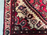 a close up of a rug with a red and blue design on it