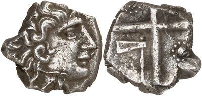 a close up of two silver coins with a cross on them