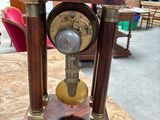 a small wooden clock on a table in a room
