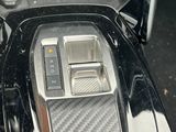 a close up of a car ' s gear box with a phone in it