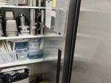 a refrigerator that has many dishes on the shelves