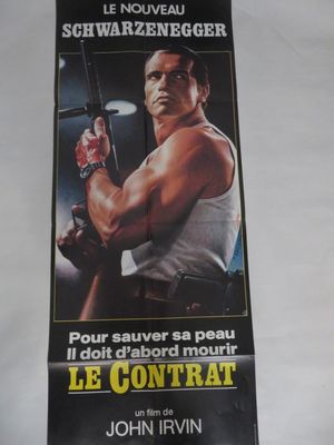 L'affiche du film « Le Contrat » est accrochée au mur.
