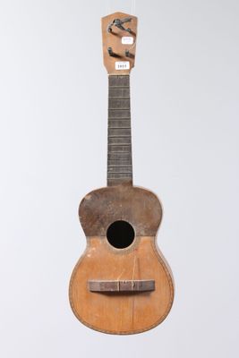 a small wooden guitar hanging from the ceiling