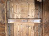 a wooden cabinet with a door open on the floor