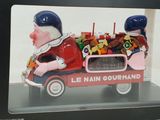 a red toy truck with a man and a woman in it