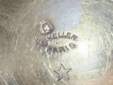 a close up of a silver plate with a star on it