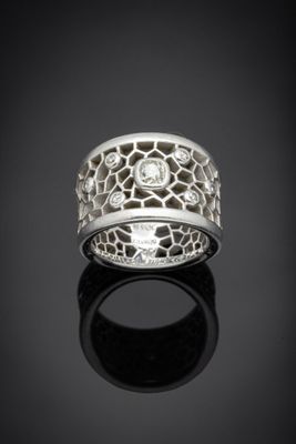 a close up of a silver ring on a black surface