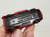 someone is holding a red and black lighter in their hand