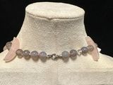 pink and grey beaded necklace on a white mannequin