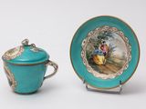 a tea cup and saucer with a picture on it