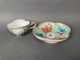 a cup and saucer with a floral design on it