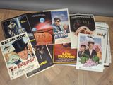 many movie posters on the floor of this room