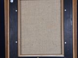 an old wooden easel with a black frame on a blue background